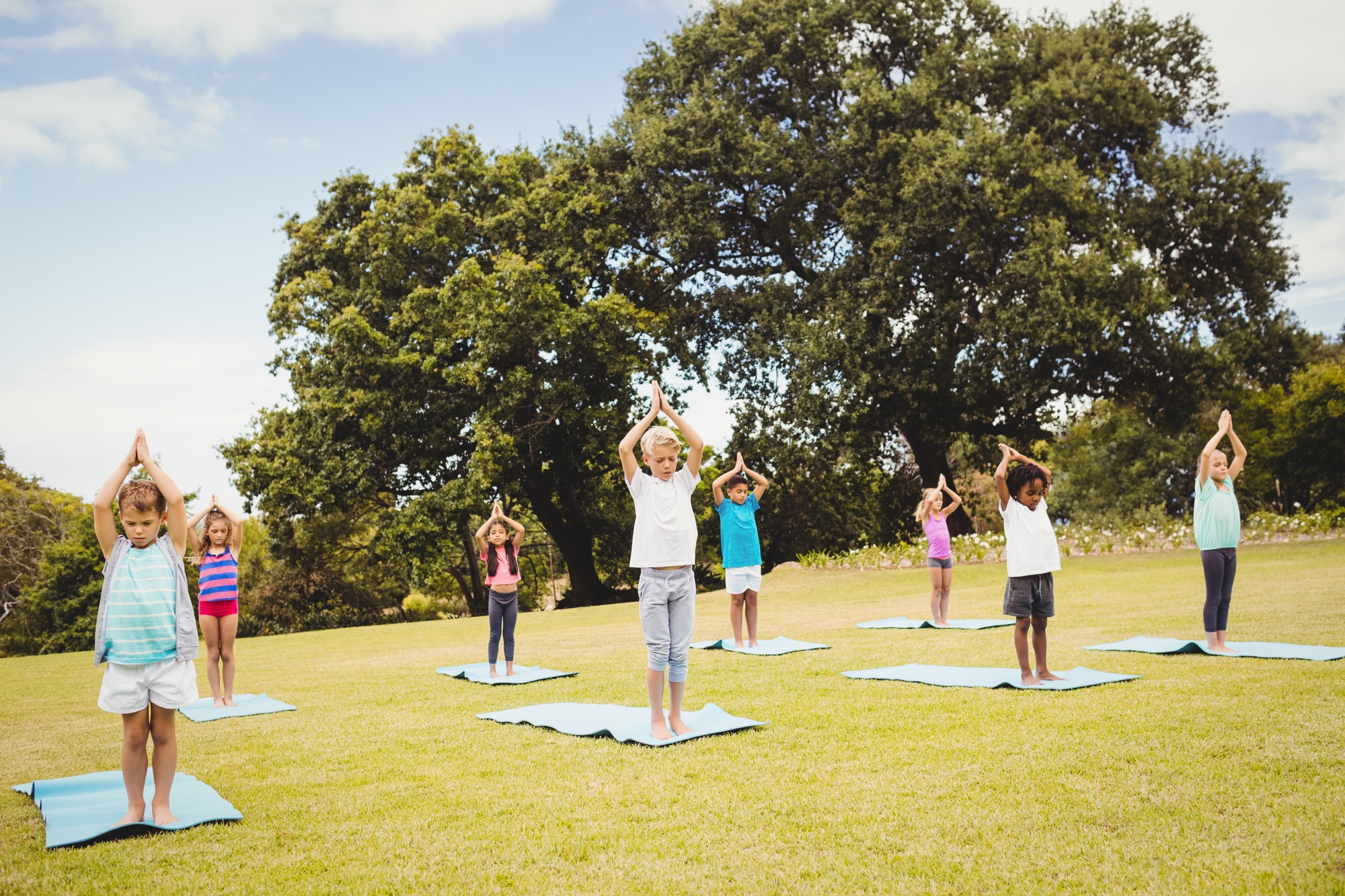 Children standing and doing yoga